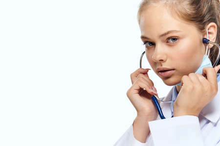 female laboratory assistant in white coat chemical solution analyzes researchの写真素材