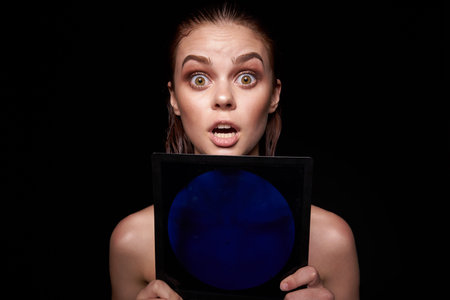 sexy woman bare shoulders clean skin wet hair dark backgroundの写真素材