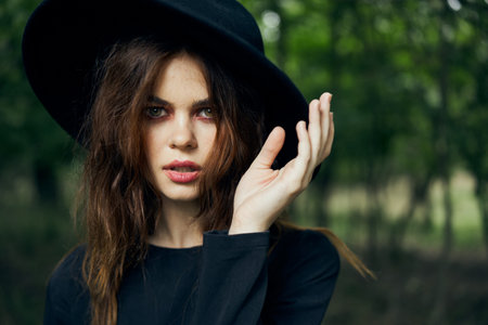 woman dressed as a witch in the forest Halloween fantasy ritual
