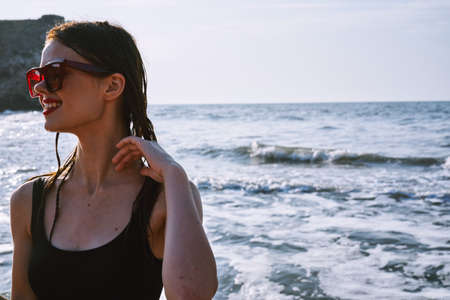 pretty woman in a black swimsuit with a watermelon in her hands summer Oceanの写真素材