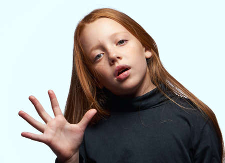 red-haired girl in a black sweater planning close-upの写真素材