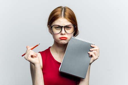 Business woman in red dress notebook pencil professionalsの写真素材