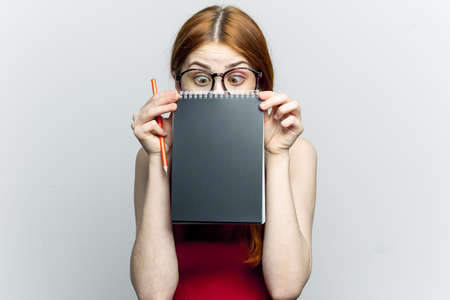 Business woman in red dress notebook pencil professionalsの写真素材