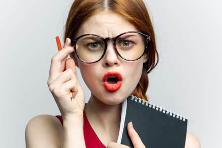 woman secretary in glasses with a notebook in the hands of the managerの写真素材