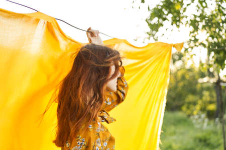 cheerful woman in yellow dress posing nature summerの写真素材