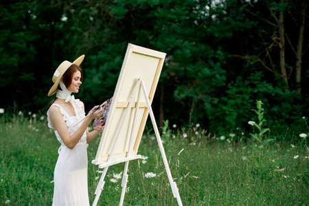 pretty woman in white dress outdoors drawing art creativeの写真素材