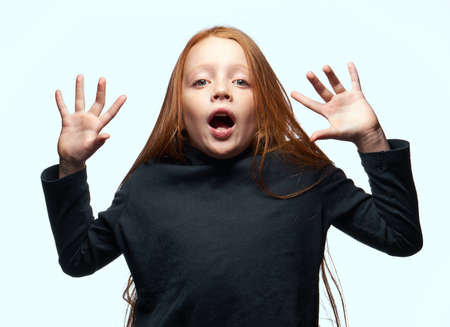 red-haired girl in a black sweater planning close-upの写真素材