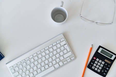 wireless keyboard on desktop cup documents officeの写真素材