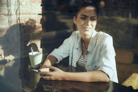 Business woman with phone in cafe vacation breakfastの写真素材