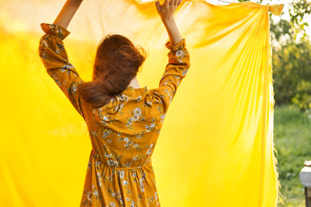 woman in dress posing nature yellow cloth fresh airの写真素材