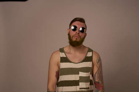 national bearded man in a striped jersey hipster tattoos on his armsの写真素材