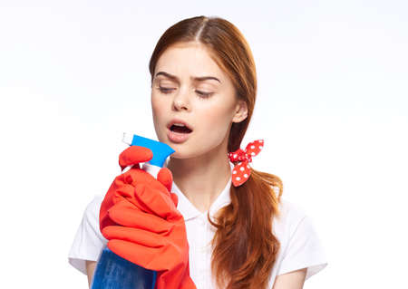 cheerful woman in red rubber gloves detergent washing windowsの写真素材