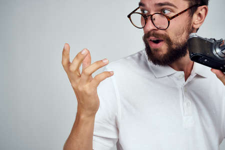 male photographer in glasses with a camera professionals modern styleの写真素材