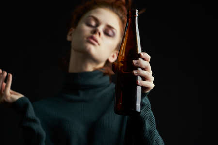 woman with cigarette bottle of alcohol bruises under eyes problems depressionの写真素材