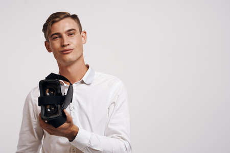 pretty man virtual reality glasses high-tech simulator light backgroundの写真素材