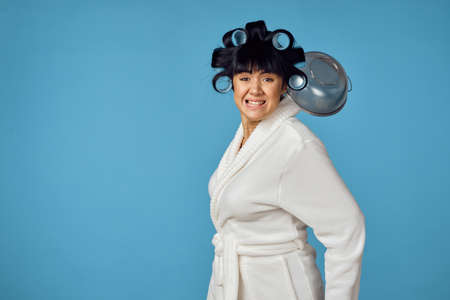 Woman in white robe kitchen utensils homeworkの写真素材