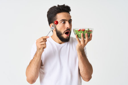 bearded man plate with vegetable salad eating healthの写真素材