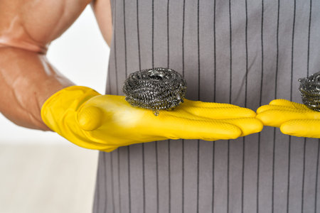 pumped up man in rubber gloves metal sponges close-up