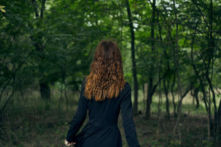 cheerful woman witch in the forest posing fantasyの写真素材