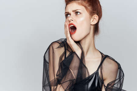woman in black dress cosmetics emotions posing glamorの写真素材