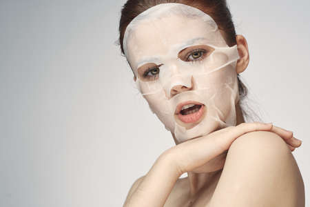 woman with bare shoulders face mask skin care proceduresの写真素材