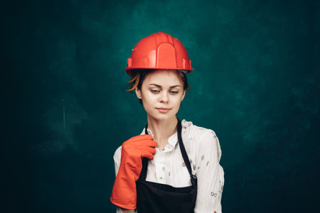 woman in black apron orange hard hat protection cleaningの写真素材