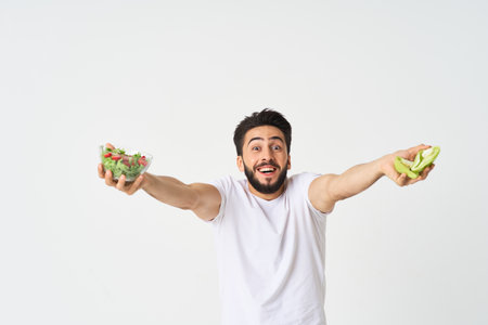 man in white t-shirt plate salad healthy food dietの写真素材