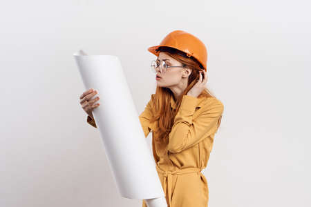 female engineer in orange hard hat blueprints architectの写真素材
