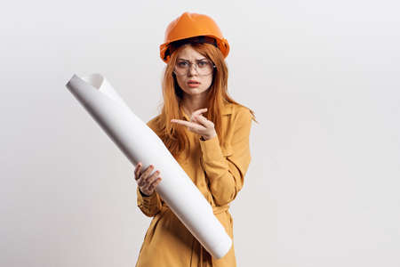 female engineer in orange hard hat blueprints architectの写真素材