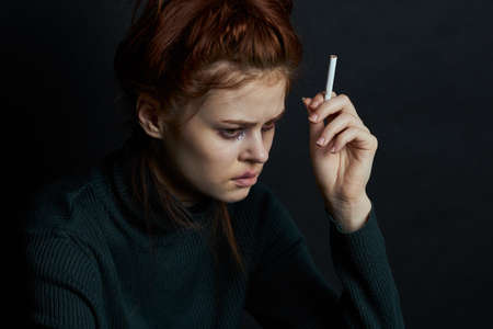woman with fingal capital smokes a cigarette depression abuseの写真素材