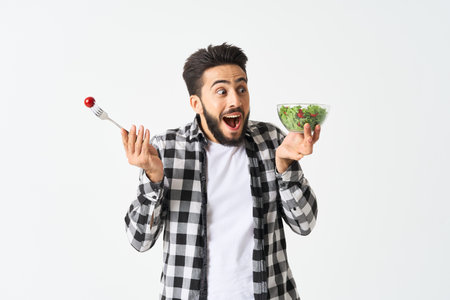 cheerful man in plaid shirt plate with salad healthy food