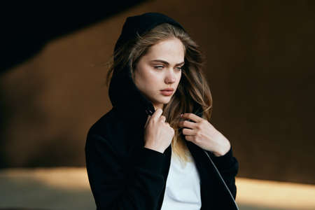 woman in a black sweater on the street walk posingの写真素材