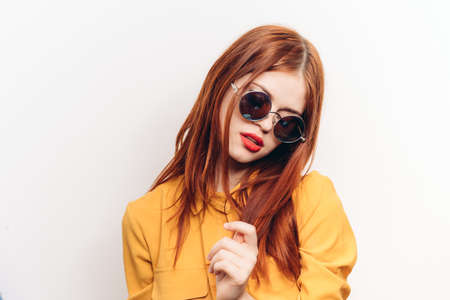 attractive woman hairstyle glamor sunglasses glamor light backgroundの写真素材