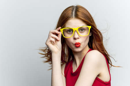 pretty woman yellow glasses hairstyle fashion close-upの写真素材
