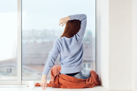 woman near the window dreamy look rest at home comfort