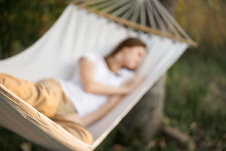 woman sleeping in hammock outdoors leisure lifestyleの写真素材