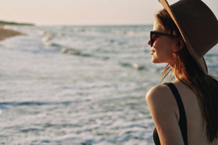 woman walking on the beach hat travel vacation sunの写真素材