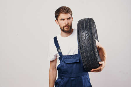 male worker auto mechanic machine professional light backgroundの写真素材