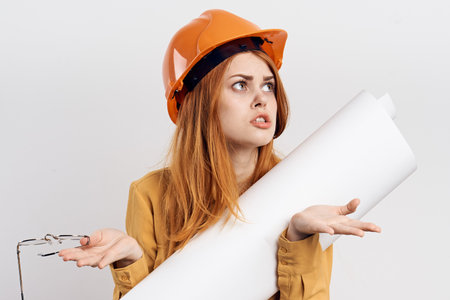female engineer in orange hard hat blueprints architectの写真素材
