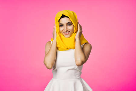 muslim woman in hijab posing fashion ethnicity pink backgroundの写真素材