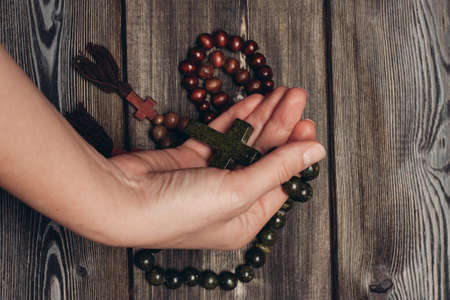 beads with orthodox cross wooden background catholicism christianityの写真素材
