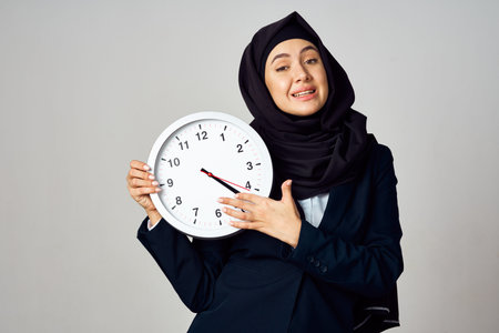 muslim woman with clock in hands office work lifestyle