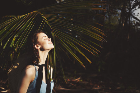 woman in swimwear palm leaf jungle island beach sun