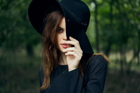 woman dressed as a witch in the forest Halloween fantasy ritualの写真素材