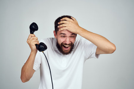 bearded man in shirt talking on the phone retro styleの写真素材