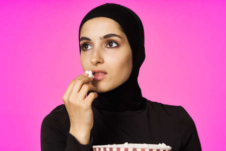 Muslim woman entertainment cinema popcorn fashion model ethnicityの写真素材