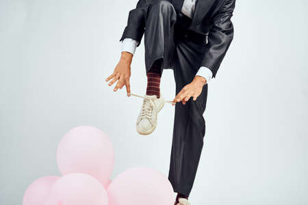 a man in a suit and sunglasses pink balloons manager holidayの写真素材