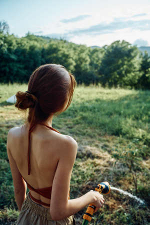 woman watering plants in the garden nature growingの写真素材