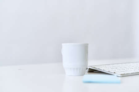 wireless keyboard on desktop cup documents officeの写真素材
