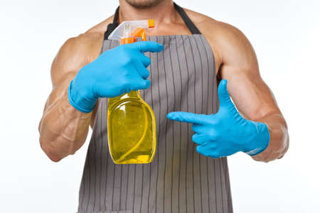 man in apron detergent cleaning service light backgroundの写真素材